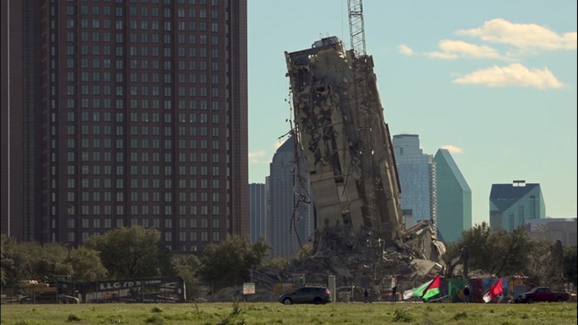 Texans braved the wind to check out the latest attraction in the DFW Metroplex, a failed building implosion now nicknamed the 'Leaning Tower of Dallas'.
