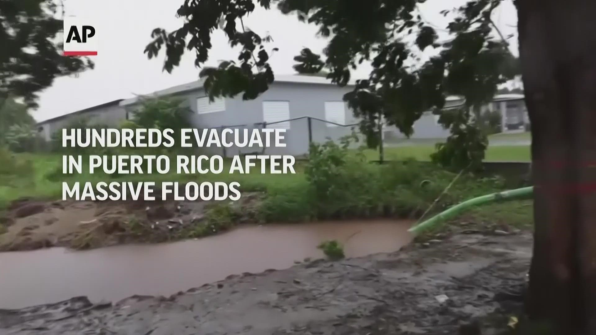 City workers in the town of Loiza on the northeastern coast of Puerto Rico went house to house on Sunday asking people to evacuate ahead of expected floods.