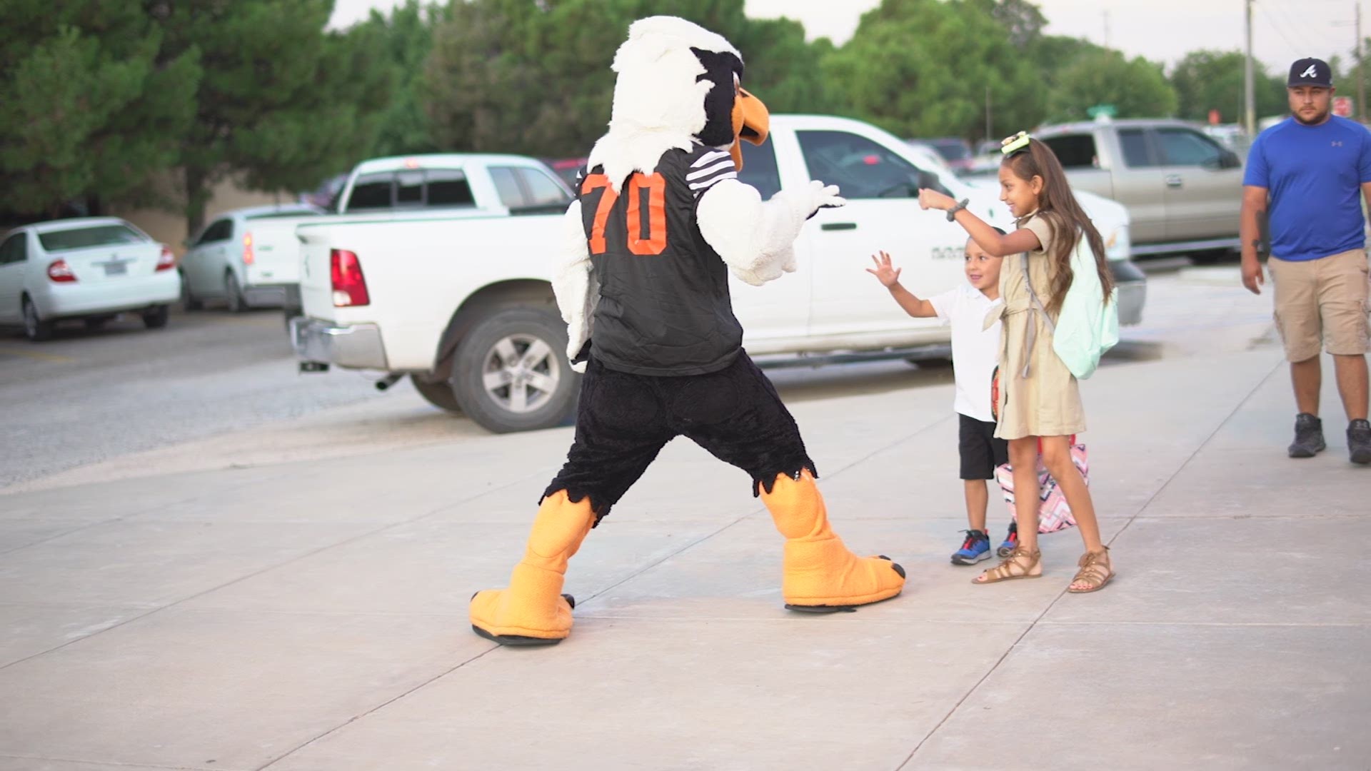 UTPB athletes, cheerleaders, and band members greet ECISD students on their first day of school.