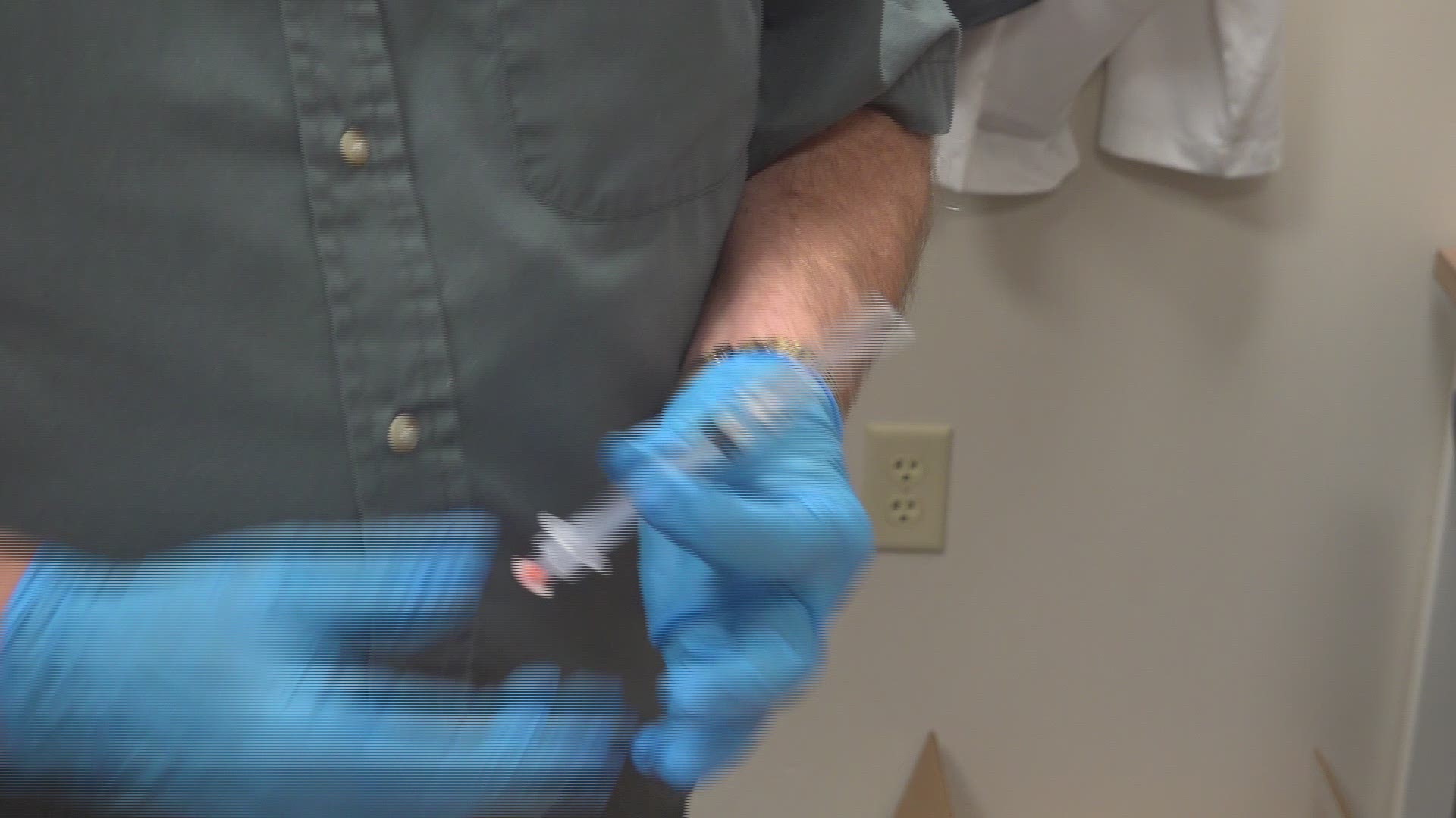 Local pharmacist prepares a flu shot
