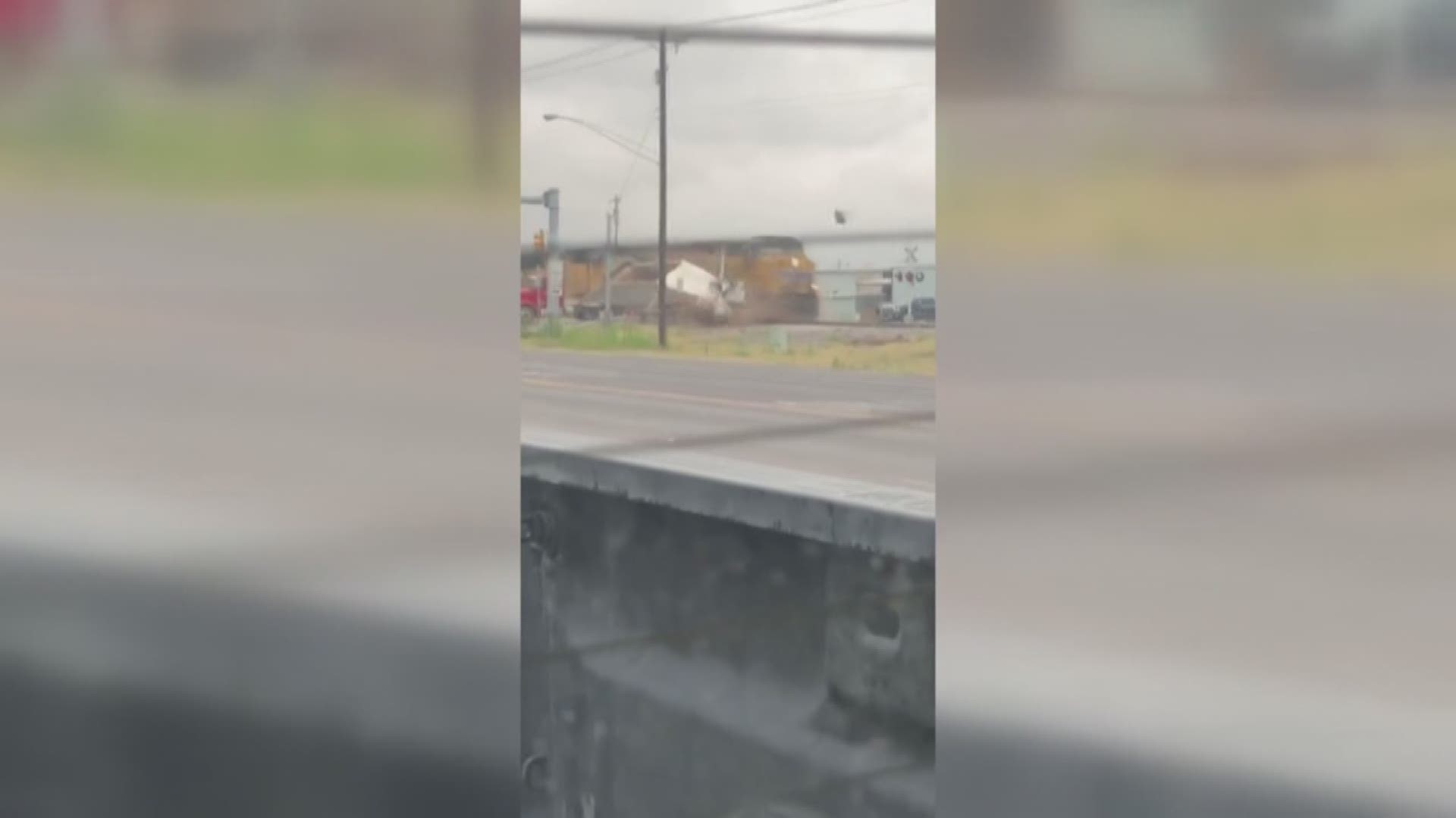 Captured on camera, a truck stopped on the tracks and was struck by a train.