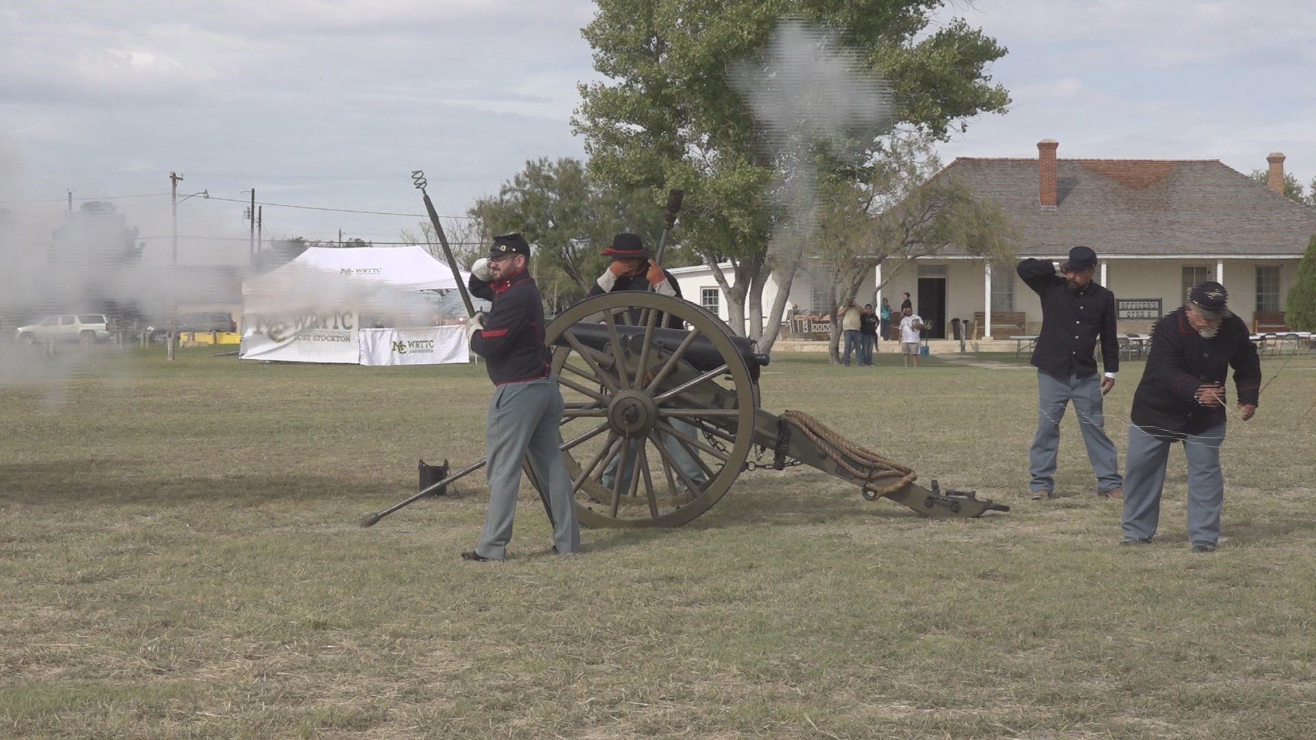 Re-enactors help teach history to visitors with the help of a cannon.