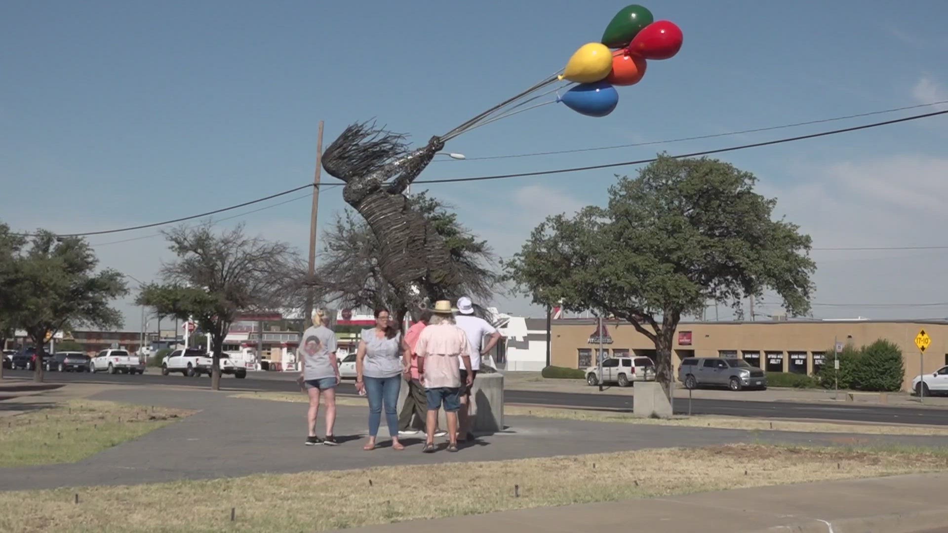 "Girl with Balloons" sits on Wall Street and Front Street.