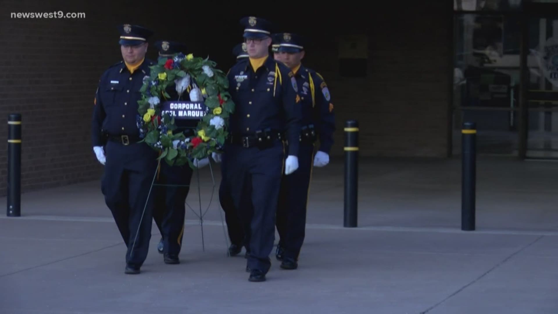 The honor guard placed a wreath at the memorial statue honoring an officer killed in the line of duty in 2007.