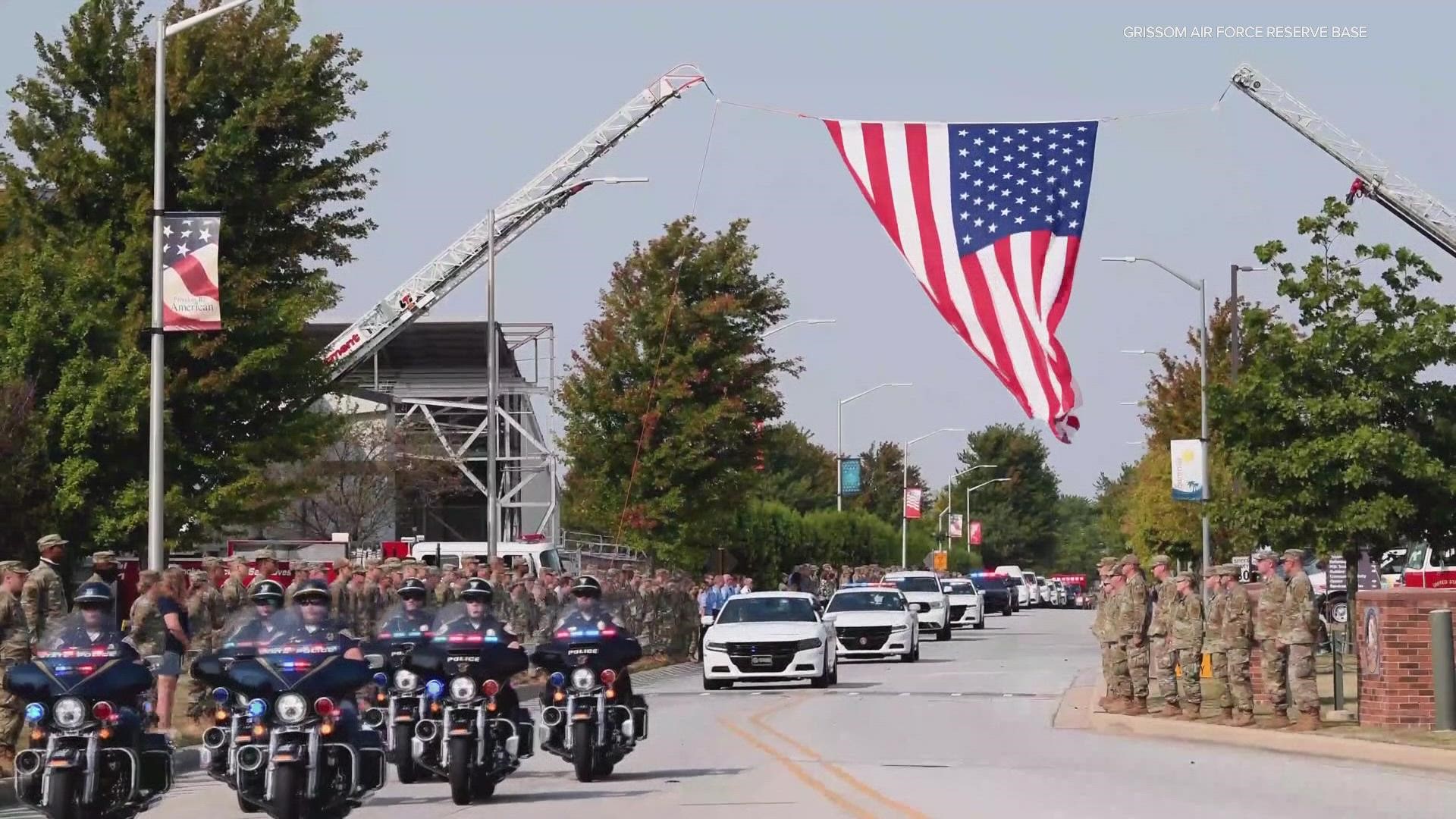 A crowd of military members saluted as the hearse carrying the remains of Cpl. Humberto Sanchez passed by on its way to bring the fallen Marine home.