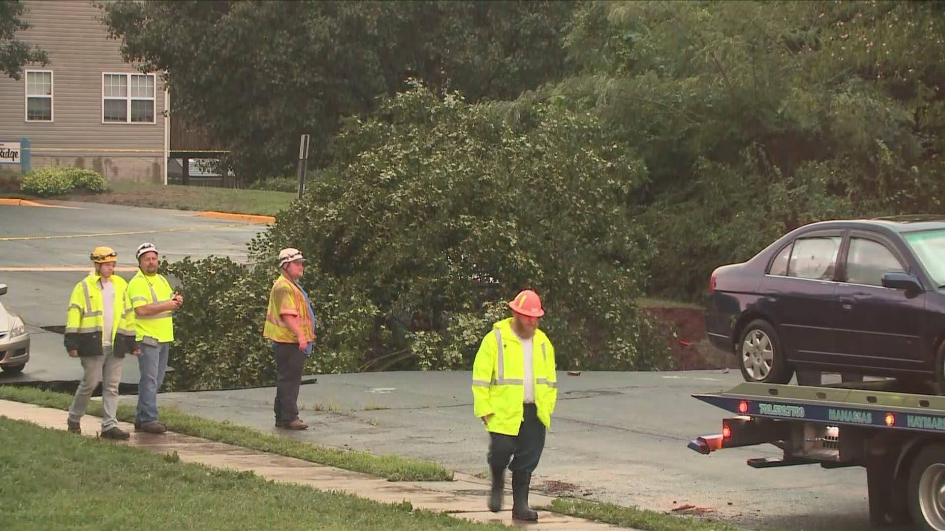 Crews have removed several cars in the area as they work to fix the sinkhole.